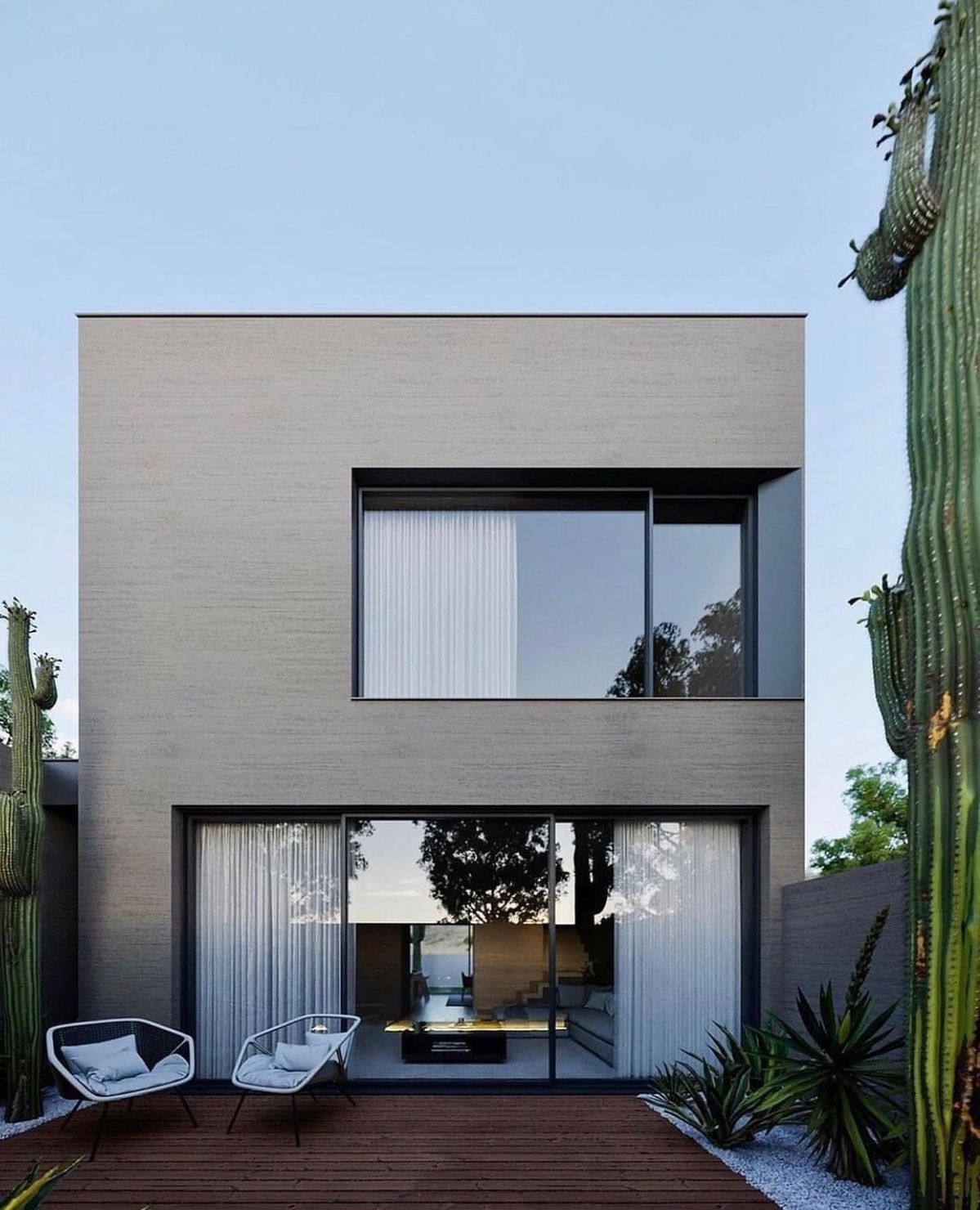 Gạch ốp mặt tiền tông xám xi măng nhạt, bề mặt mịn, vân nhẹ đều màu. Tổng thể tạo cảm giác tối giản, hiện đại và rất “đằm” khi nhìn từ xa.