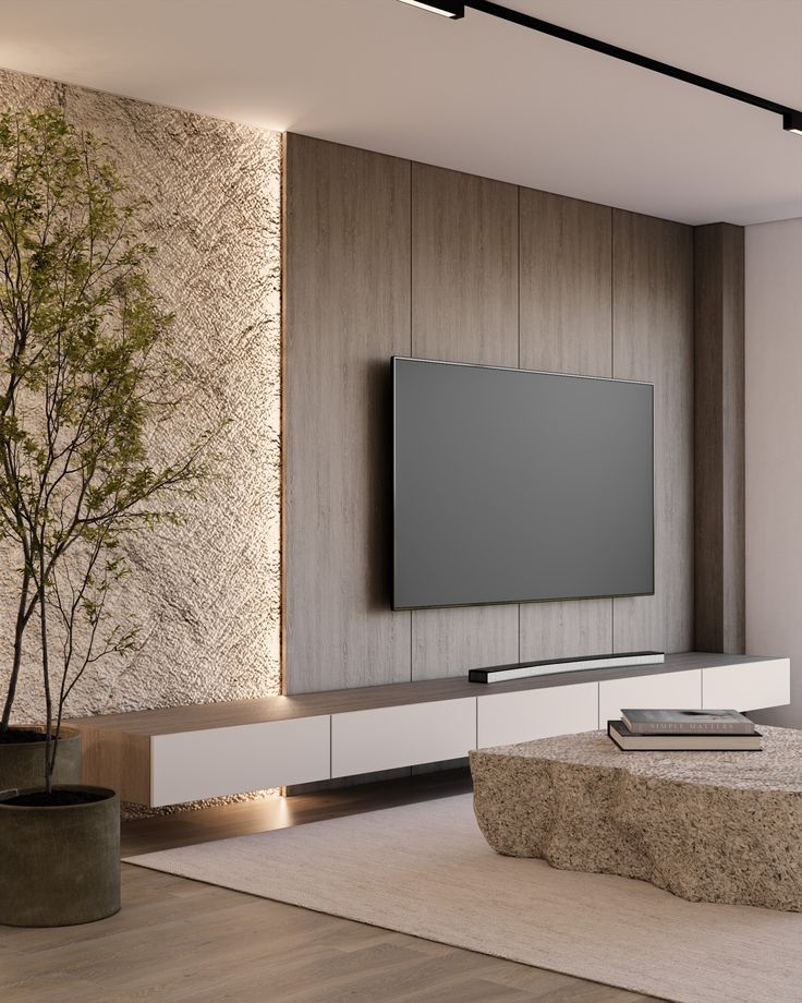 Vách TV ốp gạch giả gỗ kết hợp mảng hiệu ứng đá/nhám: tạo điểm nhấn mạnh mà vẫn sang.