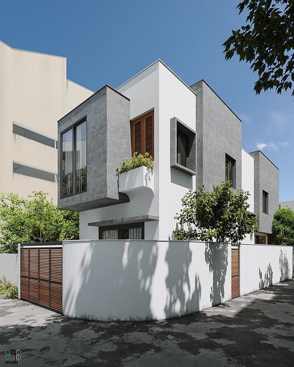 Mặt tiền gạch xám kết hợp mảng trắng và lam gỗ tạo tổng thể hiện đại, tinh giản nhưng vẫn ấm áp.