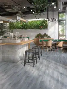 Gạch giả gỗ màu xám kết hợp cây xanh tạo nên không gian café hiện đại, trẻ trung và gần gũi thiên nhiên.